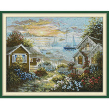Load image into Gallery viewer, Peaceful Seaside embroidery kit showing coastal landscape with red accents on printed canvas