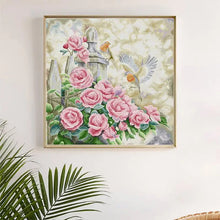 Load image into Gallery viewer, Finished summer garden embroidery displayed in bright, sunny room setting