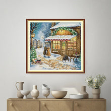 Load image into Gallery viewer, Framed winter scene painting on a wall above a cabinet with decorative items.
