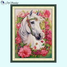 Load image into Gallery viewer, Mystical white horse cross stitch design with celestial patterns on fabric