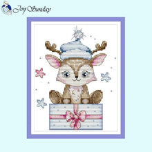 Load image into Gallery viewer, Cross-stitched design of a deer with a blue hat and pink bow on a light blue background.
