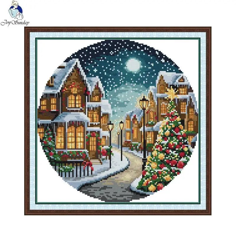 Framed winter scene with decorated houses and Christmas tree, featuring a brand logo.