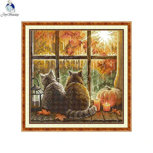 Load image into Gallery viewer, Two cats looking out a window with Halloween decorations, including pumpkins and a full moon.
