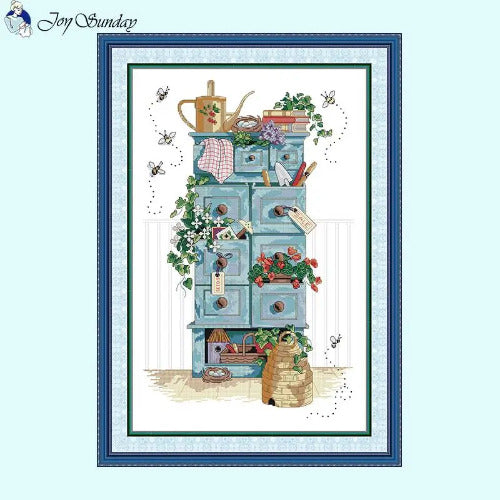 Gardening sentiments still life cross stitch kit showing botanical tools design