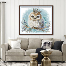 Load image into Gallery viewer, Framed artwork of an owl with a crown on a wall above a sofa.
