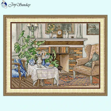 Load image into Gallery viewer, Fireside still life cross stitch pattern with warm colors and rustic decor details.
