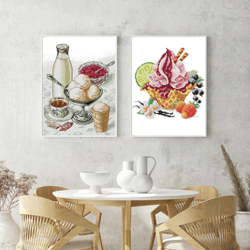 Two framed artworks of ice cream and a table setting on a wall above a dining table.