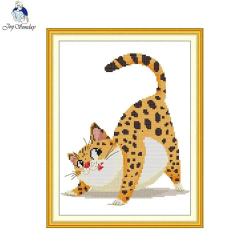 Cross-stitched cat design in a gold frame on a white background